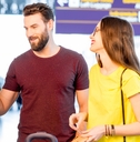Couple withdrawing money from an ATM at an airport