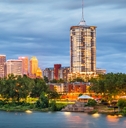 beautiful view of lake with a row of trees and majestic buildings in the background at Tulsa, Oklahoma, USA