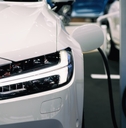 An environmentally-friendly vehicle hybrid electric car's battery is being charged by a sustainable energy source. .