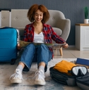 woman reading travel map surrounded with luggage