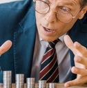 businessman looking at silver coins