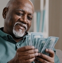 elderly man counting money