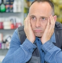 male warehouse employee resting on desk