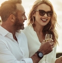 Happy couple having white wine outdoors