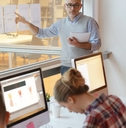 male professor teaching economics to students