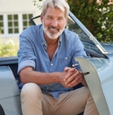 senior man in vintage sports car