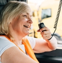 female truck driver talking by radio