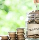 hand putting coins in glass jar