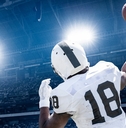 quarterback throwing football in professional game