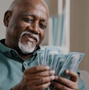 senior man counting banknotes