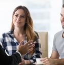 young couple consulting male finance advisor