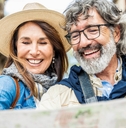 senior couple reviewing map while traveling