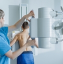 medical technician adjusts x-ray machine