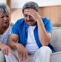 stressed senior couple reviewing bills