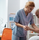 nurse holding her patients hand