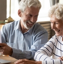 senior couple reviewing bills at table