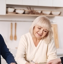 senior couple signing documents with agent