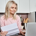 senior woman reviewing bills