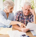 stressed senior couple reviewing bills