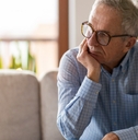 worried senior man sitting alone