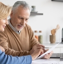 couple reviewing bills at home kitchen