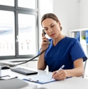 female nurse on phone at work