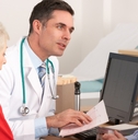 male doctor talking to senior couple
