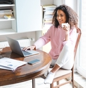holding cup with using laptop
