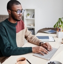 man wearing glasses while working