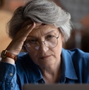 confused senior woman using laptop