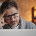 senior man stressed at laptop screen