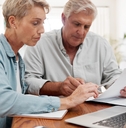 senior couple reviewing mortgage expenses together