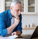 mature man looking at laptop