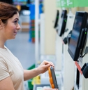 woman using self-checkout counter