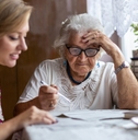 woman helping elderly grandmother