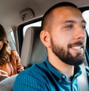 Smiling man driving woman