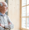 senior man gazing through window