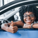 excited african american woman in car