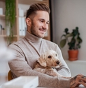 dog sitting at the desk indoors