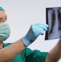 respiratory therapist looking at lungs scan
