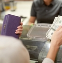 paying money at store cash register
