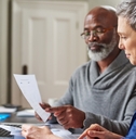 multi ethnic senior couple reviewing taxes