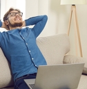calm young man sits on sofa
