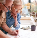mature couple signing paperwork