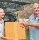 senior couple picking packages from car