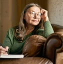 retired female in stylish round glasses