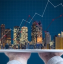 buildings and tablet real estate concept 
