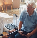 senior couple consulting female travel agent