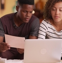 african american couple reviewing bills together