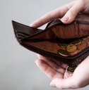 holding purse with coins